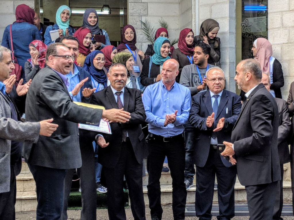 Fellow Bret Vlazny, Dean of the Faculty of Arts, and branch Director welcome a delegation from the City Council for a visit to the campus of Al-Quds Open University.