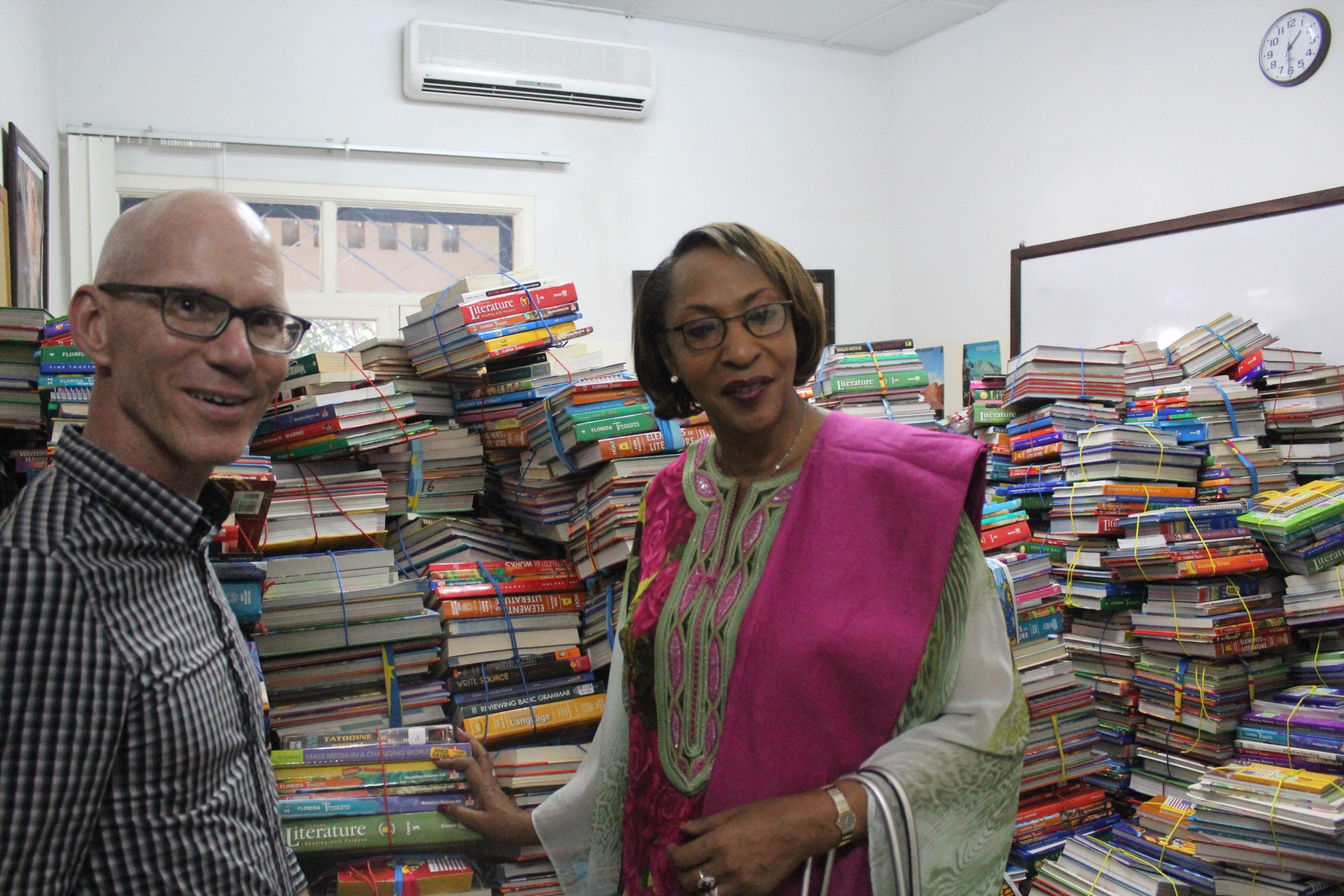 Ambassador Jim Swan and the Vice Minister of Education with thousands of free books