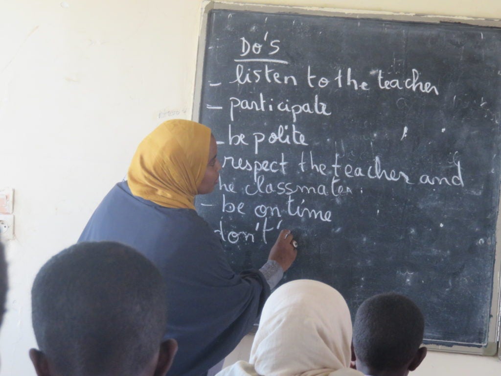 Workshop participants completes task on blackboard