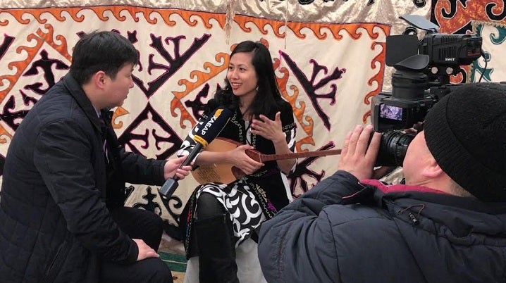 Fellow learns how to play local music instrument in Kazakhstan