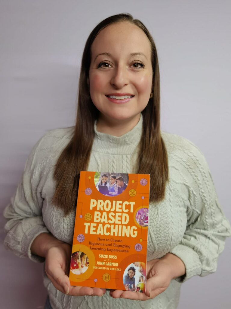 A medium shot of Virtual Educator Ashley Stamper holding a copy of the textbook Project Based Teaching